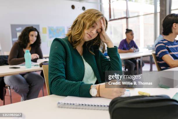 tire high school student writing in notepad - school exam stock pictures, royalty-free photos & images