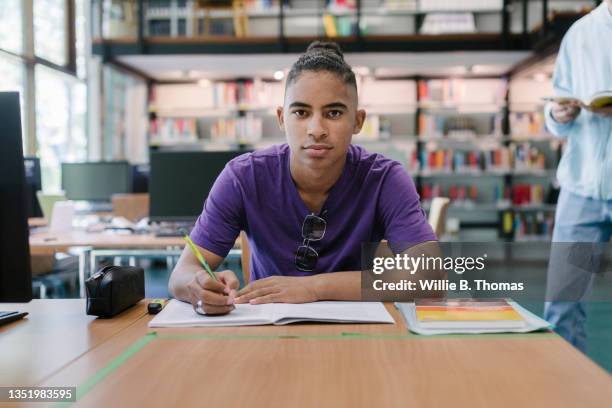 portrait of high school student studying at desk - showing pen stock pictures, royalty-free photos & images