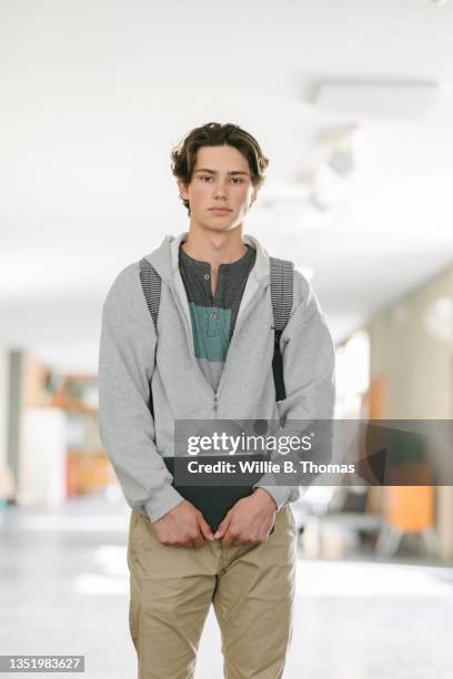 portrait of high school student in hallway - high school portrait stock-fotos und bilder