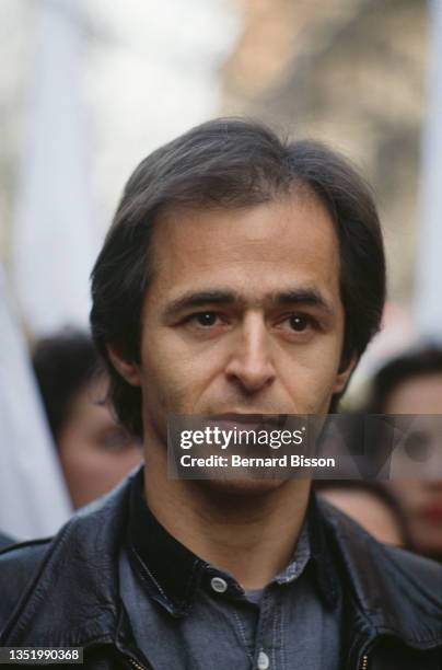 French singer Jean-Jacques Goldman attends SOS Racisme demonstration to protest against hate crimes in France on March 15, 1990 in Paris, France.