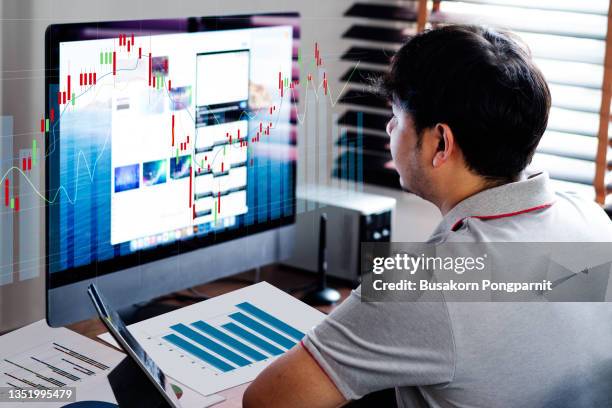 businessman trading growth graph on business and investment. - young businessman using a virtual screen stockfoto's en -beelden