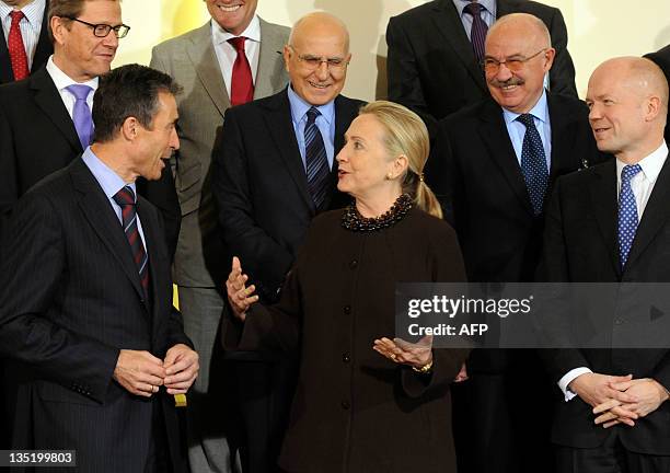 Secretary General Anders Fogh Rasmussen speaks with US Secretary of State Hillary Clinton while Britain's Foreign Affairs Minister William Hague ,...