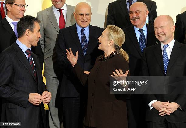 Secretary of State Hillary Clinton talks to NATO Secretary General Anders Fogh Rasmussen , Britain's Foreign Affairs Minister William Hague ,...