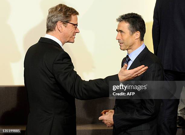 Germany's Foreign Affairs Minister Guido Westerwelle speaks with NATO Secretary General Anders Fogh Rasmussen following a NATO Foreign Affairs...