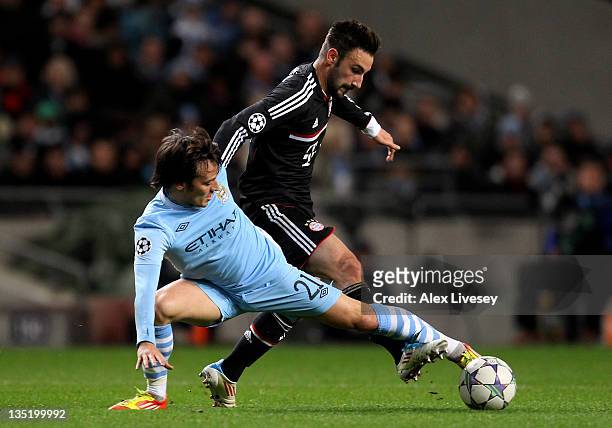 David Silva of Manchester City competes with Diego Contento of FC Bayern Muenchen during the UEFA Champions League Group A match between Manchester...
