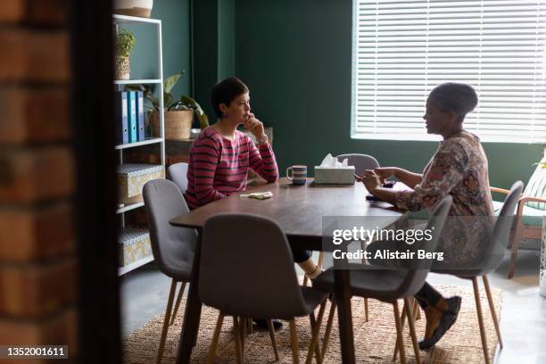 two women talking at counselling session in an office boardroom - emotional support at work stock pictures, royalty-free photos & images