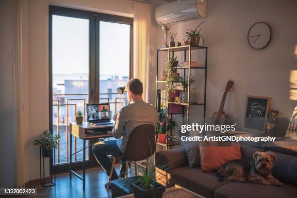 businessman having a video call meeting with his team. - working behind laptop stockfoto's en -beelden