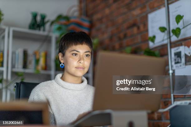 young businesswomen speaking to colleagues on a video call - philippines stock pictures, royalty-free photos & images