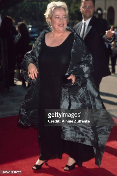 American actress Kathy Bates, wearing a black dress with a grey wrap coat, attends the 51st Primetime Creative Arts Emmy Awards, held at the Pasadena...