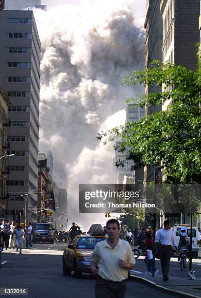 People run down Church Street just after the north tower of the World Trade Center collapsed. September 11, 2001 in New York City.