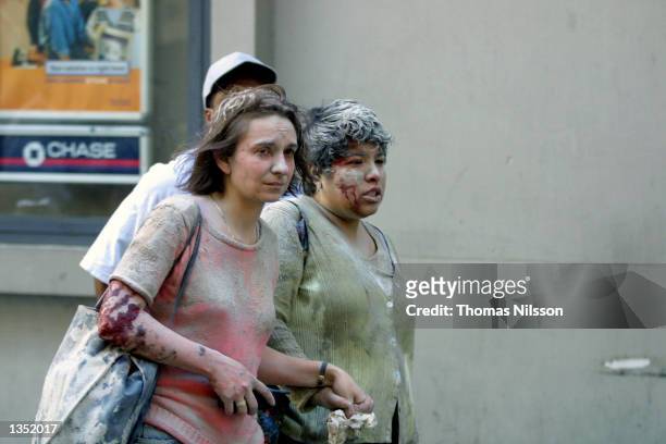 Injured people flee the World Trade Center area after the south tower collapsed September 11, 2001 in New York City.
