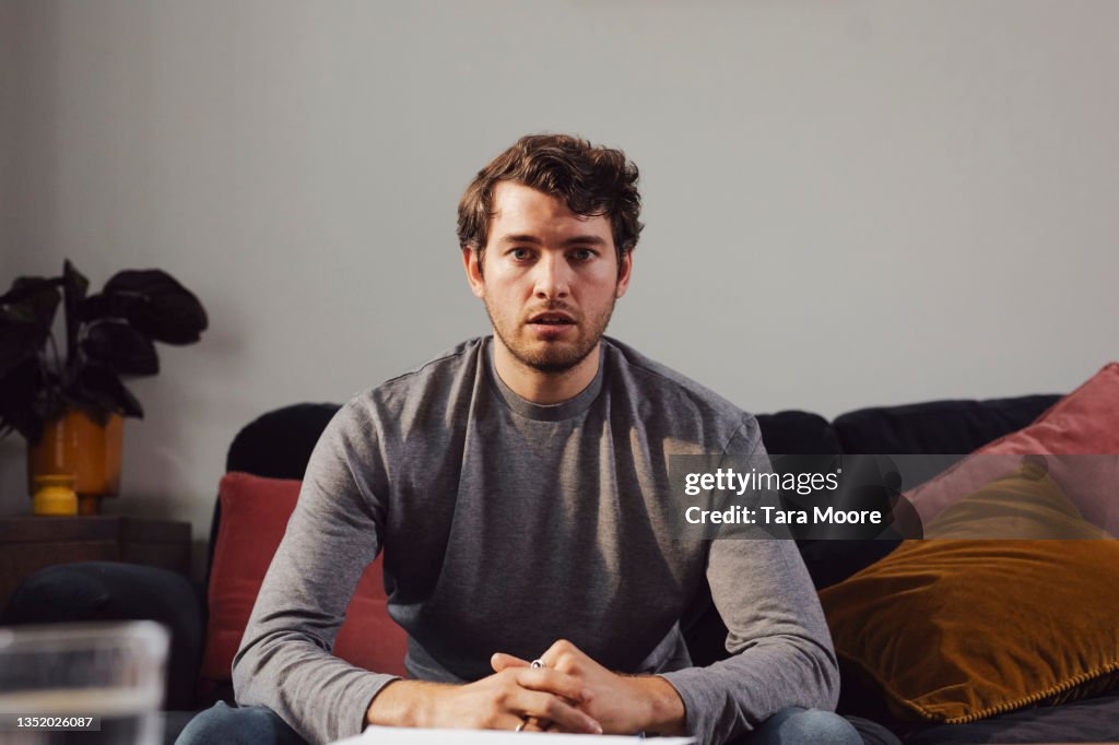 Young man facing the camera looking worried.