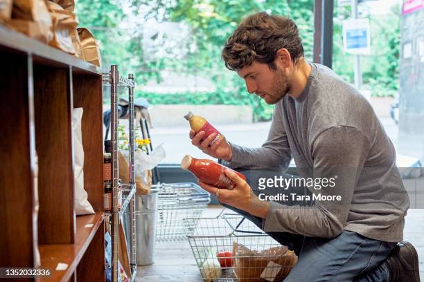 young man shopping in food store. - food market stockfoto's en -beelden