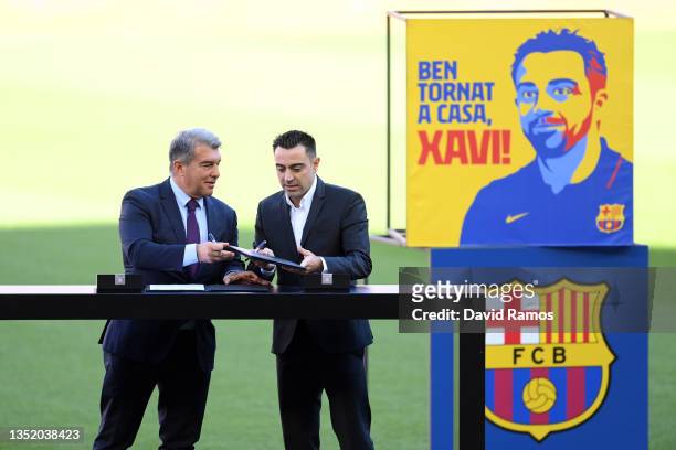 New FC Barcelona Head Coach Xavi Hernandez signs the contract together with Joan Laporta, President of FC Barcelona during a press conference at Camp...