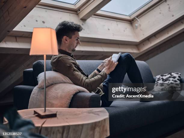 young man works from home in modern apartment - connected mindfulness work stock pictures, royalty-free photos & images