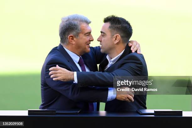 New FC Barcelona Head Coach Xavi Hernandez and Joan Laporta, President of FC Barcelona embrace each other during a press conference at Camp Nou on...