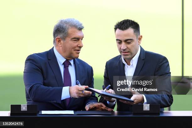 New FC Barcelona Head Coach Xavi Hernandez signs the contract together with Joan Laporta, President of FC Barcelona during a press conference at Camp...