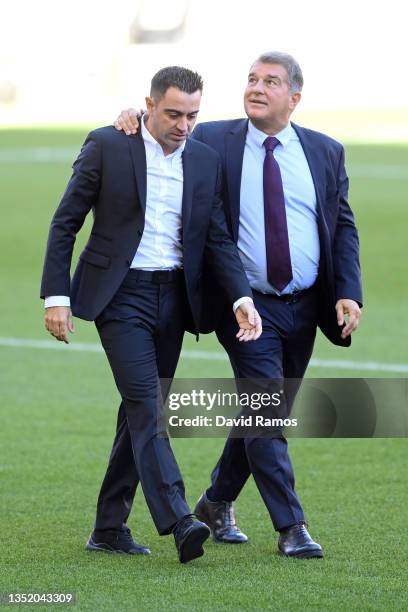 New FC Barcelona Head Coach Xavi Hernandez and Joan Laporta, President of FC Barcelona walk across the pitch during a press conference at Camp Nou on...