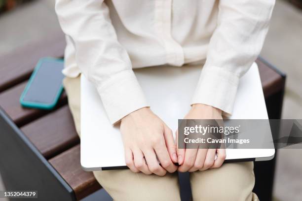 close-up of woman using cell phone and laptop - blouse stock pictures, royalty-free photos & images