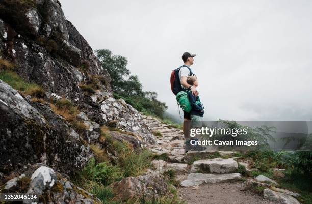 father and son climbing ben nevis mountain range in the uk - saint kitts and nevis stock pictures, royalty-free photos & images