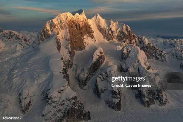 sunset light shines on snow covered peaks called moose's tooth i - talkeetna stock pictures, royalty-free photos & images