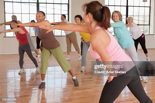 women exercising in fitness class - aerobics stock pictures, royalty-free photos & images