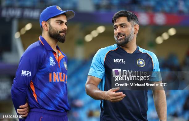 Virat Kohli of India interacts with MS Dhoni, Mentor of India ahead of the ICC Men's T20 World Cup match between India and Namibia at Dubai...