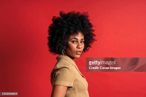 stock photo of beautiful black woman smiling and having in studio shot - confidence studio shot foto e immagini stock