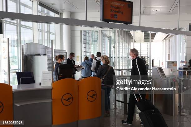 Passengers wait to board a Lufthansa flight bound non-stop for Miami at Munich Airport on the first day that U.S. Authorities are allowing tourists...