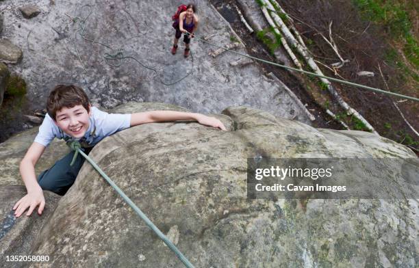 teenage boy climbing at harrisons rock close to tunbridge wells - royal tunbridge wells stock pictures, royalty-free photos & images