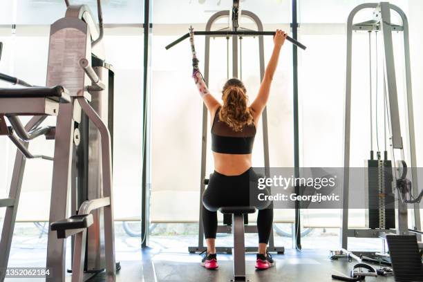 disabled woman exercise - artificial arm stock pictures, royalty-free photos & images