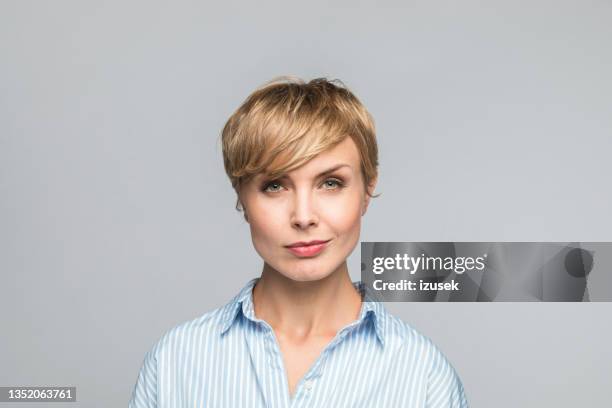 headshot of confident young businesswoman - smirk stock pictures, royalty-free photos & images