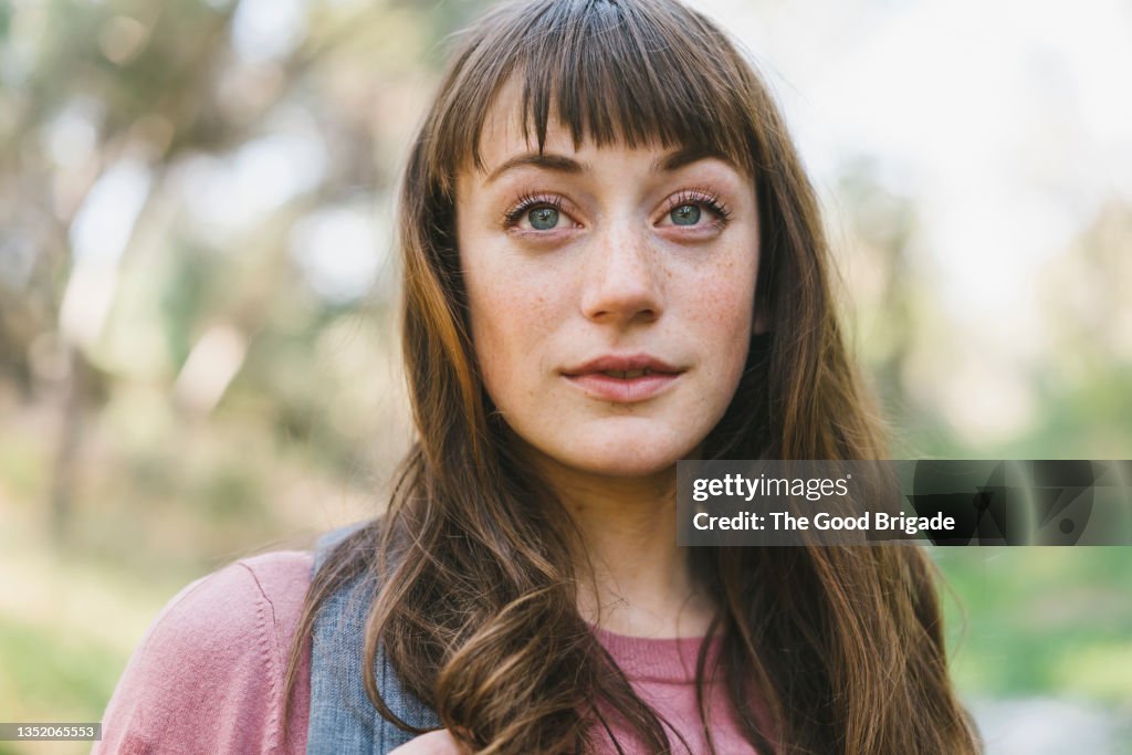 Young woman with freckle and gray eyes