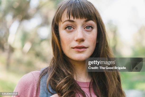 young woman with freckle and gray eyes - long hair nature stock-fotos und bilder