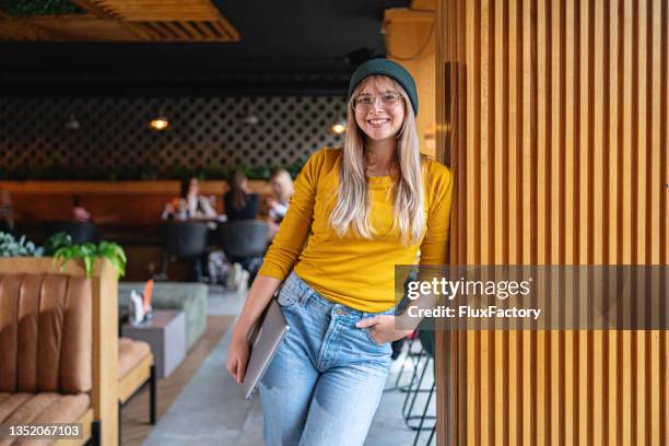 urban and modern young caucasian woman - multi colored hat stock pictures, royalty-free photos & images