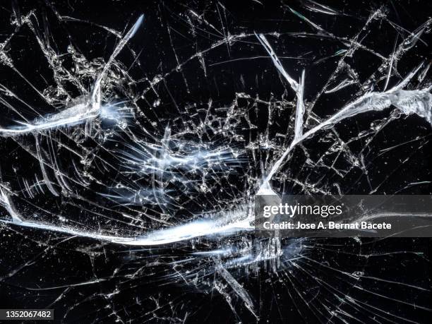 screen of a mobile phone with broken glass. - glass shatter stock-fotos und bilder