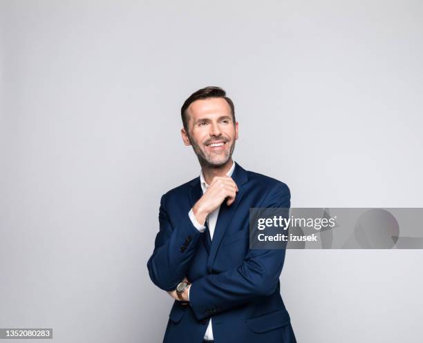 portrait of happy mature businessman - portrait gray background stock pictures, royalty-free photos & images