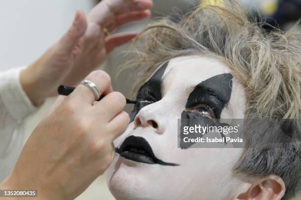 woman applying artistic make-up on boy face - spain teen face bildbanksfoton och bilder