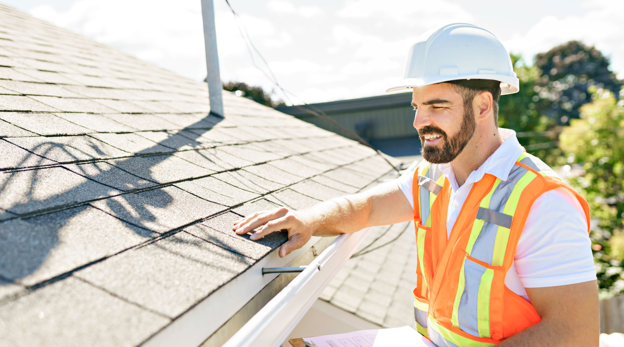 man in a hard hat, holding a clipboard, standing on the steps of an old rundown house. man in a hard hat, holding a clipboard, standing on the steps of an old rundown house.