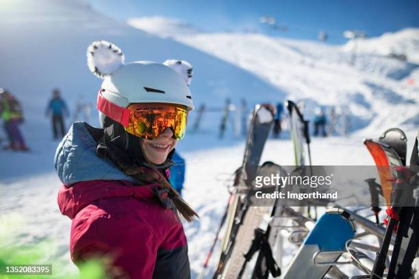 teenage girl standing by ski stands at glacier in the alps - après ski stockfoto's en -beelden