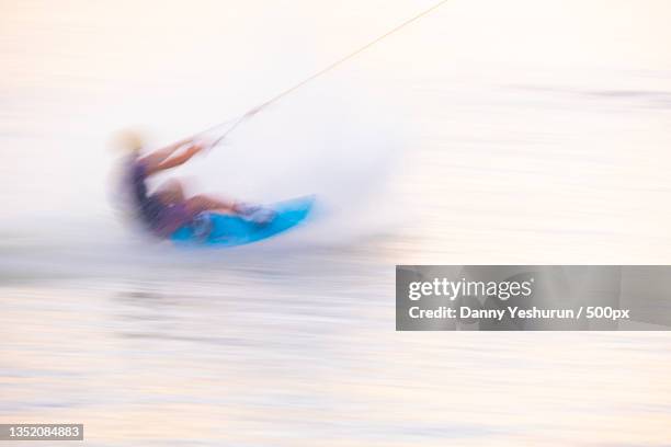 man kiteboarding in sea - kite surfing stock pictures, royalty-free photos & images