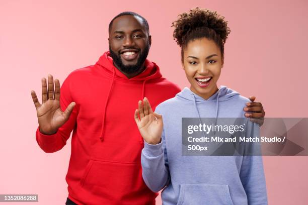 happy couple dancing against red background - introducing boyfriend stock pictures, royalty-free photos & images