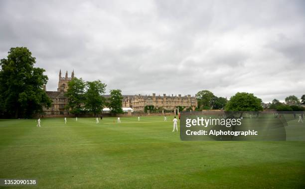 cricket pitches in front of merton college - 19th century english cricket stock pictures, royalty-free photos & images