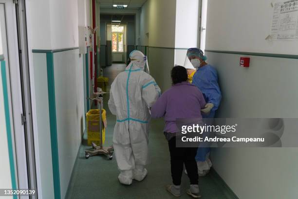 Medical staff help a COVID-19 patient inside the Covid section of the Institute of Pneumophysiology Marius Nasta, on November 8, 2021 in Bucharest,...