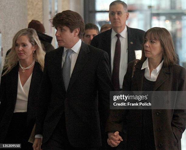 Former Illinois Governor Rod Blagojevich holds hands with wife Patti Blagojevich as they get in an elevator in the Dirksen Federal Building December...