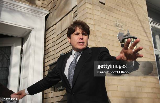 Former Illinois Governor Rod Blagojevich waves to supporters outside his home after returning from his sentencing hearing December 7, 2011 in...