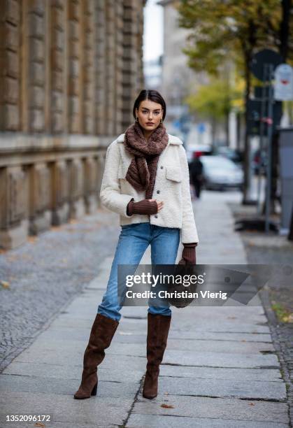 Celine Bethmann is seen wearing creme white jacket vintage, brown teddy bag Leger , brown scarf SchaI & hand warmer gloves subdued, brown boots...