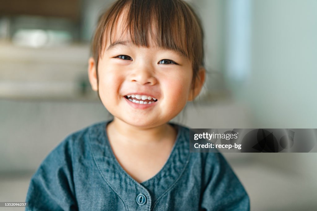 Portrait of small girl in living room at home