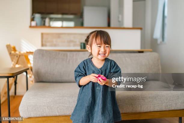 portrait of small girl in living room at home - 3 year old stock pictures, royalty-free photos & images