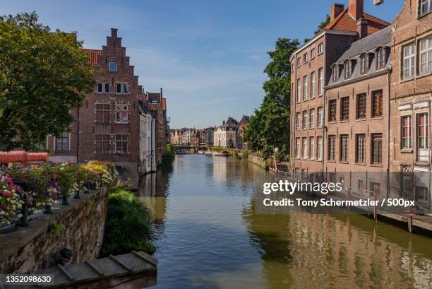 view of canal amidst buildings in city,de zuivelbrug,belgium - gand belgio foto e immagini stock